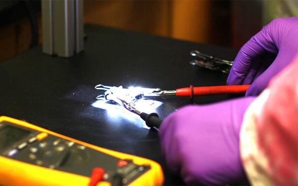 student working on solar cell