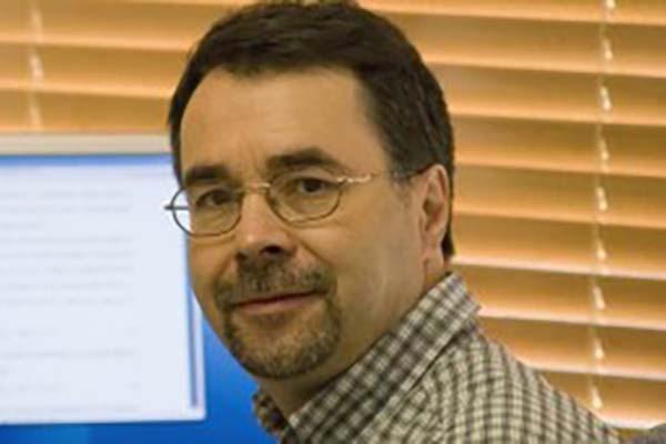 Photograph of Dr. Rafael Bruschweiler in front of computer monitor