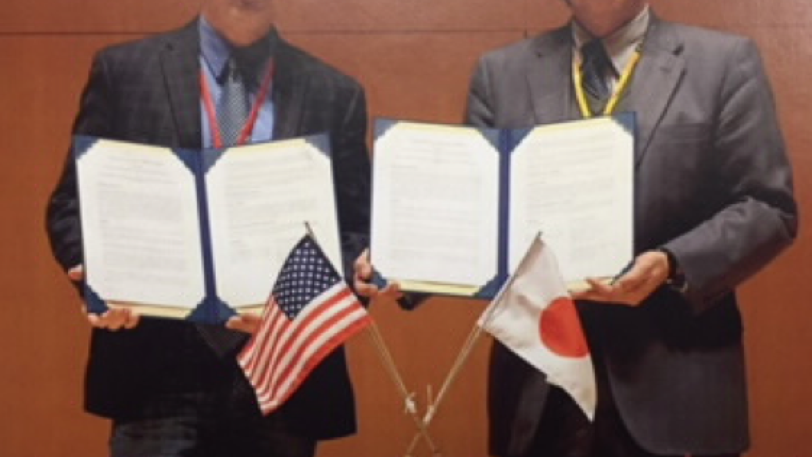 Representatives from OSU and Kyoto University hold up the Memorandum of Understanding